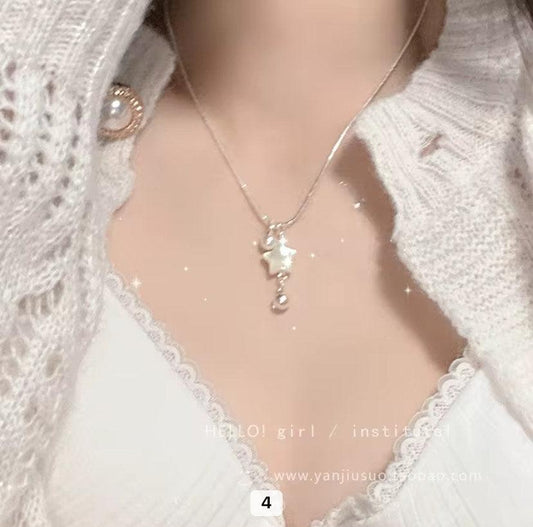 Collier pendentif étoile et perle pour femme sur décolleté en dentelle blanche